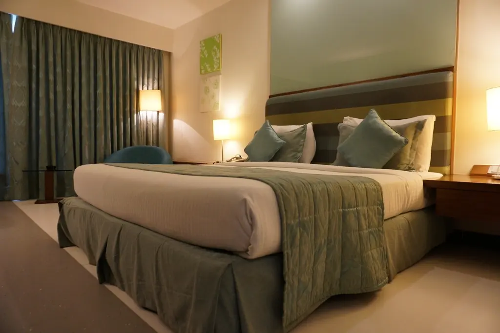 Made-up bedroom with bedside lamps