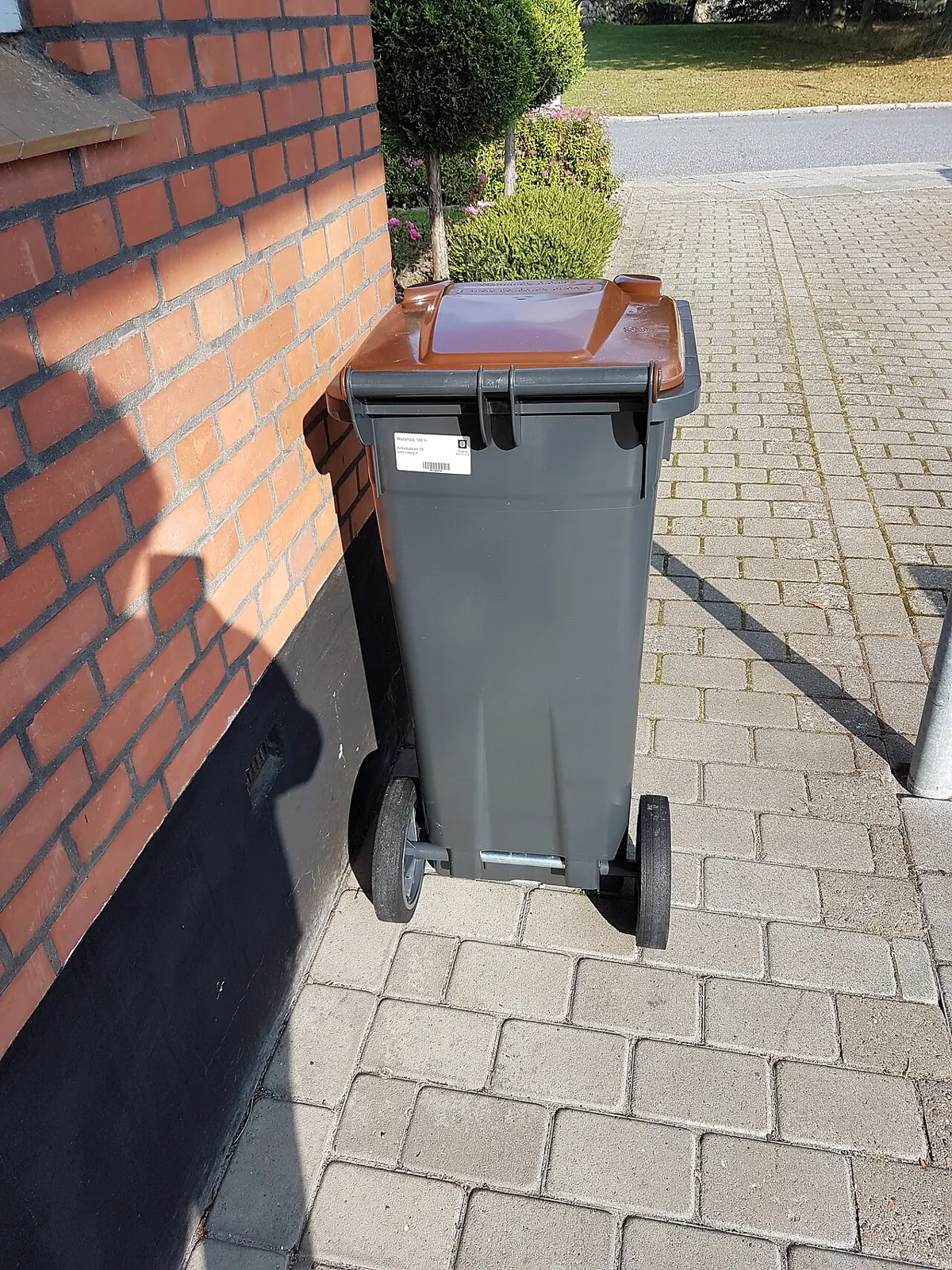 Wheeled trash bin at the curb